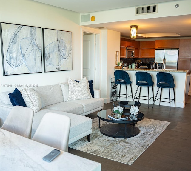 2681 N Flamingo Rd Unit 1206S, Sunrise, FL 33323 - living area with dark wood-type flooring and a tray ceiling