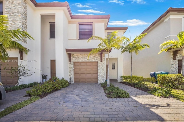 25280 SW 108th Ct, Homestead, FL 33032 - view of front facade featuring stone siding, stucco siding, and decorative driveway