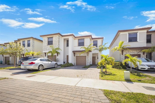 25280 SW 108th Ct, Homestead, FL 33032 - view of front of property featuring stone siding, decorative driveway, stucco siding, and a garage
