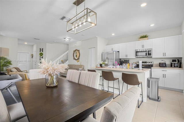 25280 SW 108th Ct, Homestead, FL 33032 - dining room featuring stairs, light tile patterned floors, recessed lighting, and a chandelier