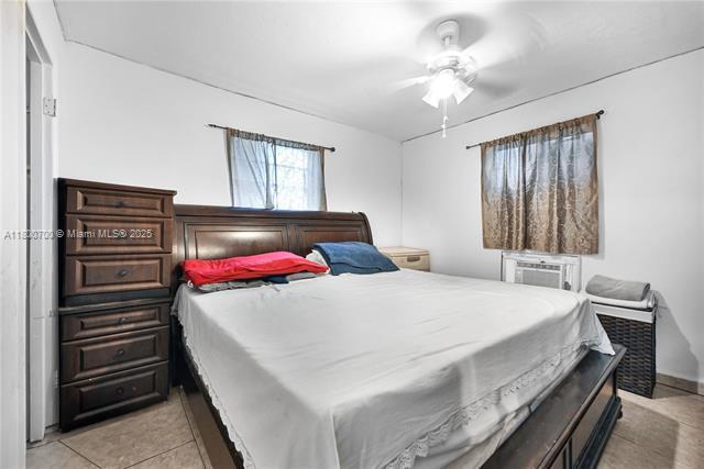 3446 NW 1st Ave, Miami, FL 33127 - bedroom with light tile patterned floors, ceiling fan, and cooling unit