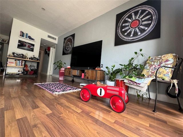 9260 Bay Harbor Ter Unit 24, Bay Harbor Islands, FL 33154 - living room featuring wood finished floors, a textured ceiling, and baseboards