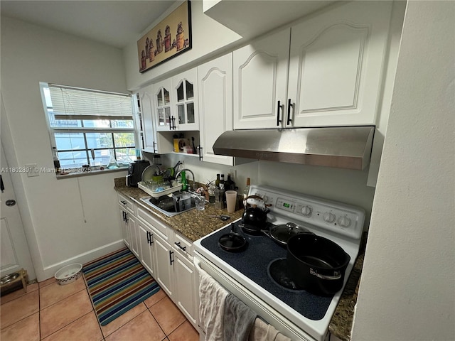 9260 Bay Harbor Ter Unit 24, Bay Harbor Islands, FL 33154 - kitchen with white electric stove, under cabinet range hood, a sink, and white cabinetry