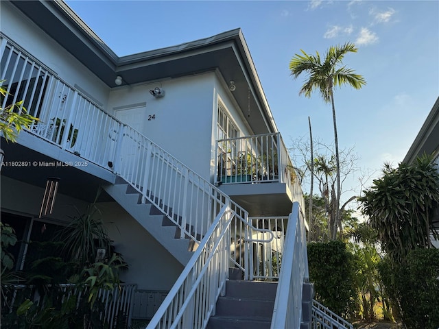 9260 Bay Harbor Ter Unit 24, Bay Harbor Islands, FL 33154 - view of side of property featuring stairs and stucco siding