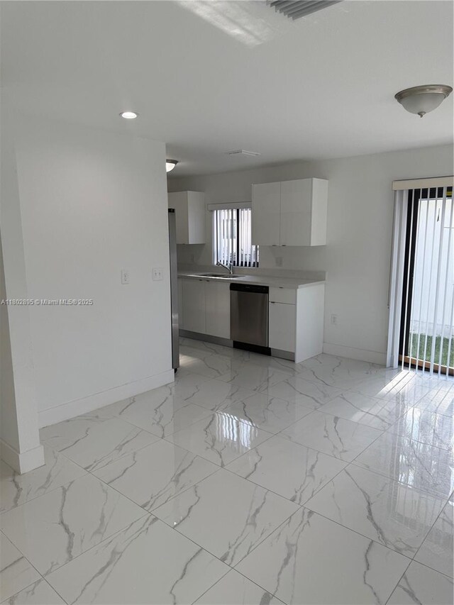210 SW 3rd St, Florida City, FL 33034 - kitchen with baseboards, appliances with stainless steel finishes, modern cabinets, white cabinetry, and light marble finish flooring