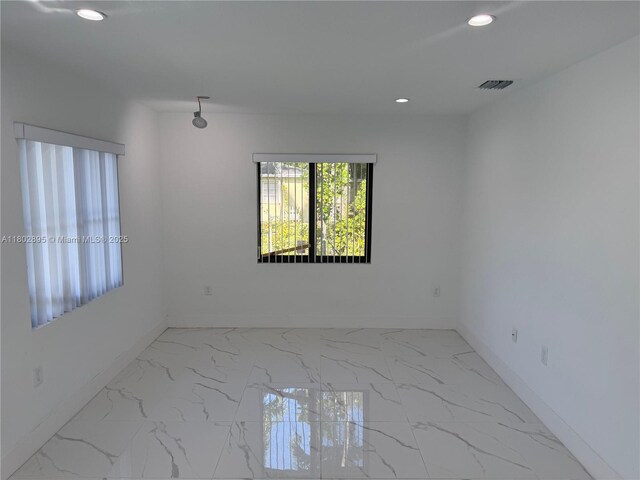 210 SW 3rd St, Florida City, FL 33034 - unfurnished room featuring baseboards, recessed lighting, and marble look tiles