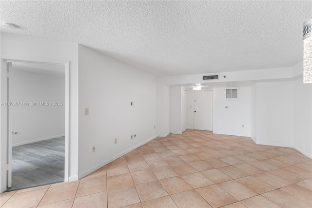 540 Brickell Key Dr Unit 904, Miami, FL 33131 - spare room with a textured ceiling, baseboards, and light tile patterned flooring