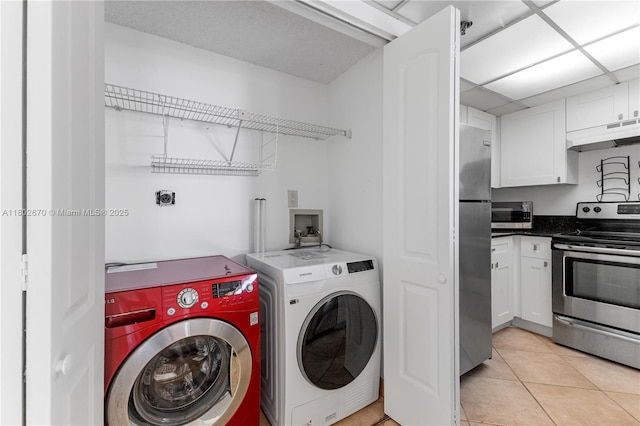 540 Brickell Key Dr Unit 904, Miami, FL 33131 - laundry room featuring washer and dryer and light tile patterned floors