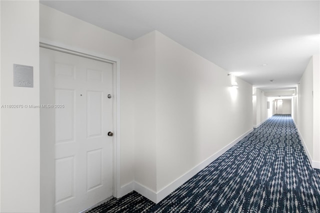 540 Brickell Key Dr Unit 904, Miami, FL 33131 - hallway featuring baseboards and dark carpet