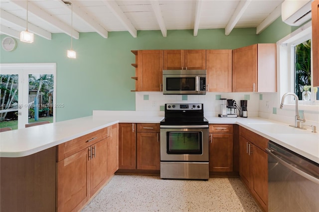 1112 N 31st Ave, Hollywood, FL 33021 - kitchen featuring stainless steel appliances, a sink, a wall mounted air conditioner, beamed ceiling, and a peninsula