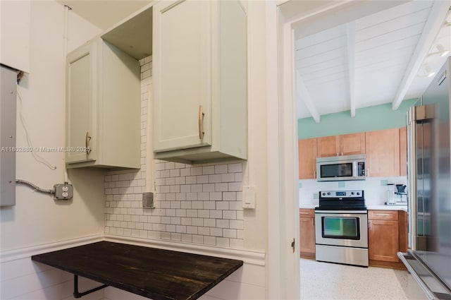 1112 N 31st Ave, Hollywood, FL 33021 - kitchen with appliances with stainless steel finishes, beamed ceiling, decorative backsplash, and light countertops