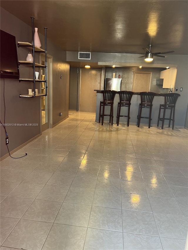 1817 S Ocean Dr Unit 718, Hallandale Beach, FL 33009 - kitchen featuring ceiling fan, tile patterned flooring, and a breakfast bar area