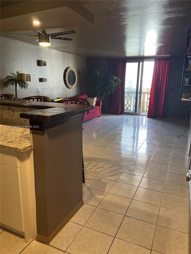 1817 S Ocean Dr Unit 718, Hallandale Beach, FL 33009 - kitchen with light tile patterned floors, a ceiling fan, and light stone countertops