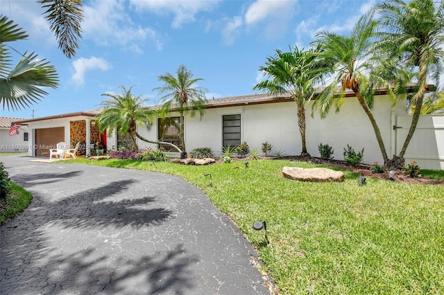 6001 SW 18th St, Plantation, FL 33317 - view of front of house with stucco siding, a garage, and driveway