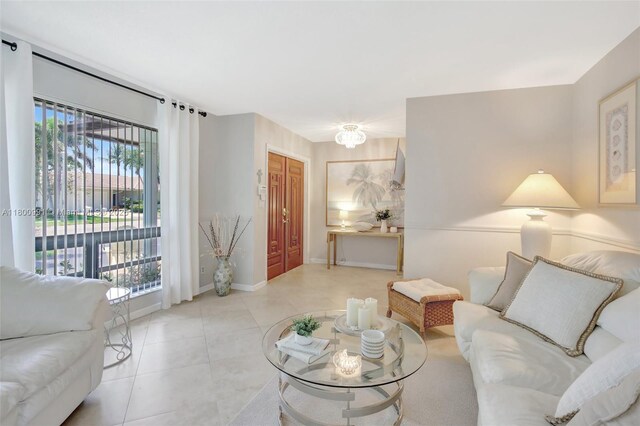 6001 SW 18th St, Plantation, FL 33317 - tiled living area with healthy amount of natural light and baseboards