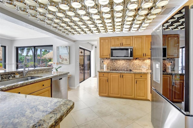 6001 SW 18th St, Plantation, FL 33317 - kitchen featuring stainless steel appliances, ornamental molding, backsplash, light stone countertops, and light tile patterned floors