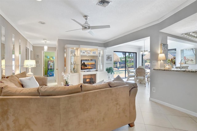 6001 SW 18th St, Plantation, FL 33317 - living area featuring crown molding, ceiling fan, light tile patterned flooring, baseboards, and a lit fireplace