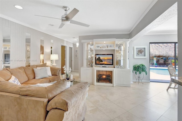 6001 SW 18th St, Plantation, FL 33317 - living area with crown molding, decorative columns, light tile patterned flooring, a ceiling fan, and baseboards