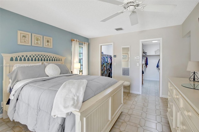 6001 SW 18th St, Plantation, FL 33317 - bedroom featuring a spacious closet, a closet, ceiling fan, light tile patterned flooring, and a textured ceiling