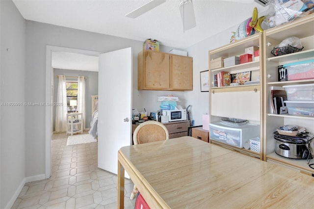 6001 SW 18th St, Plantation, FL 33317 - kitchen featuring ceiling fan, baseboards, light tile patterned floors, light brown cabinetry, and white microwave