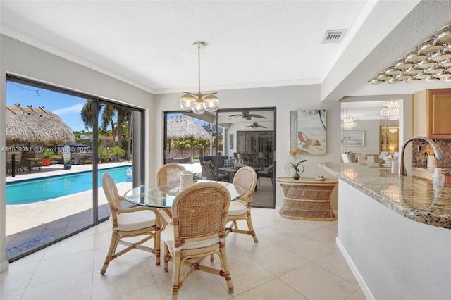 6001 SW 18th St, Plantation, FL 33317 - dining room featuring a chandelier, ceiling fan, ornamental molding, and light tile patterned floors