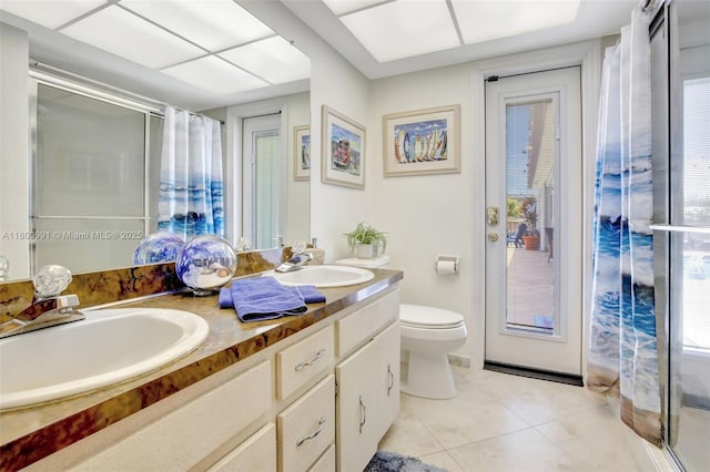 6001 SW 18th St, Plantation, FL 33317 - full bath featuring tile patterned flooring, double vanity, a shower with shower curtain, and toilet