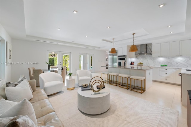 1415 Madrid St, Coral Gables, FL 33134 - living room with a tray ceiling, french doors, recessed lighting, and light tile patterned floors