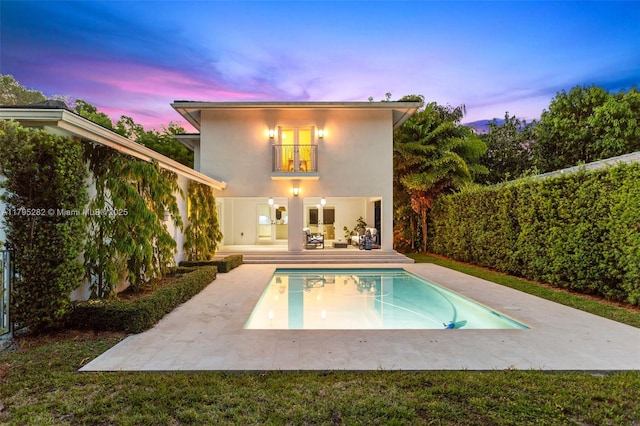 1415 Madrid St, Coral Gables, FL 33134 - back of house at dusk featuring a patio area and stucco siding