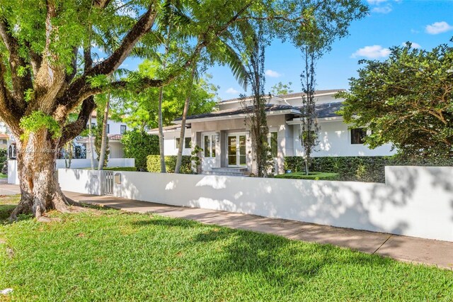 1415 Madrid St, Coral Gables, FL 33134 - view of front of house featuring stucco siding and french doors