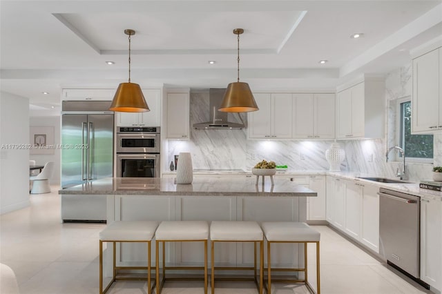 1415 Madrid St, Coral Gables, FL 33134 - kitchen featuring appliances with stainless steel finishes, a sink, wall chimney range hood, a tray ceiling, and tasteful backsplash