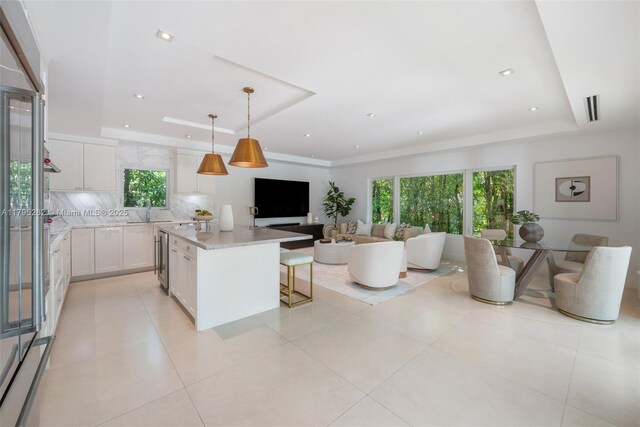 1415 Madrid St, Coral Gables, FL 33134 - kitchen featuring open floor plan, a tray ceiling, plenty of natural light, a kitchen island, and recessed lighting