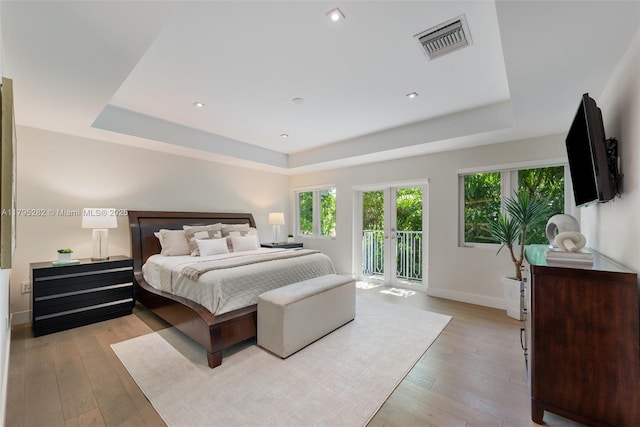 1415 Madrid St, Coral Gables, FL 33134 - bedroom with a tray ceiling, access to outside, baseboards, hardwood / wood-style flooring, and recessed lighting