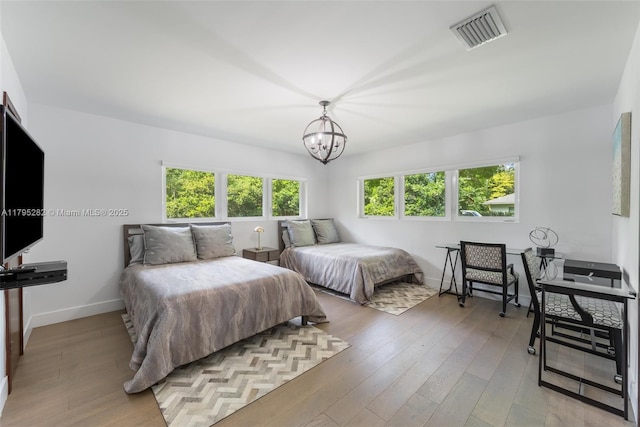 1415 Madrid St, Coral Gables, FL 33134 - bedroom with a chandelier, light wood-type flooring, and baseboards