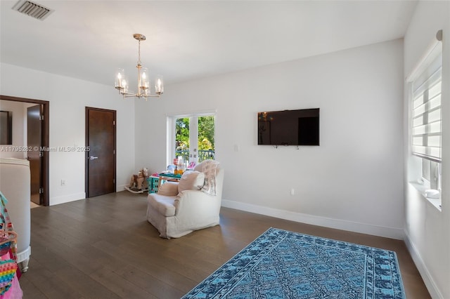 1415 Madrid St, Coral Gables, FL 33134 - living area with a chandelier, baseboards, and wood finished floors