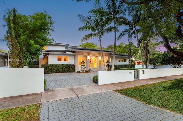 1415 Madrid St, Coral Gables, FL 33134 - view of front of property featuring stucco siding, a fenced front yard, and a gate