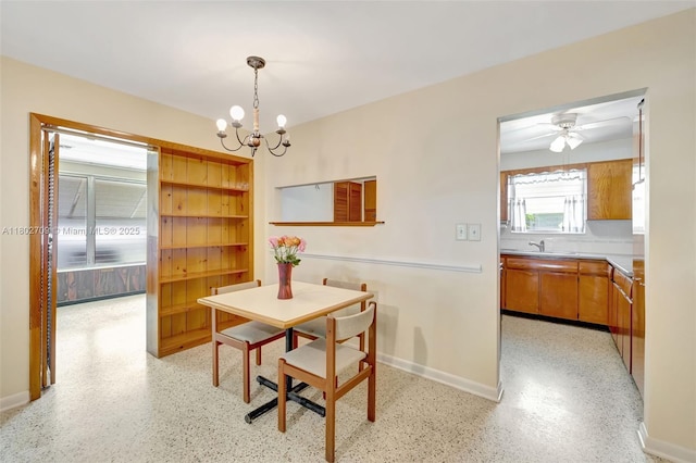 1920 SW 65th Ter, North Lauderdale, FL 33068 - dining area with a chandelier, baseboards, and dark aggregate flooring