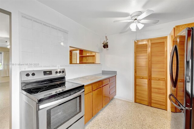 1920 SW 65th Ter, North Lauderdale, FL 33068 - kitchen featuring stainless steel electric range oven, ceiling fan, freestanding refrigerator, dark aggregate flooring, and light countertops