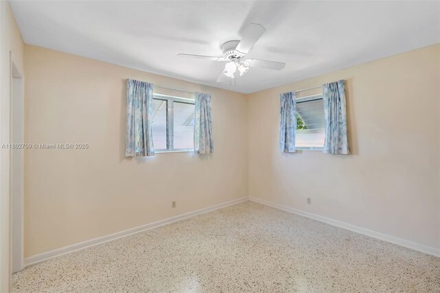 1920 SW 65th Ter, North Lauderdale, FL 33068 - unfurnished room featuring speckle patterned floor, healthy amount of natural light, and baseboards