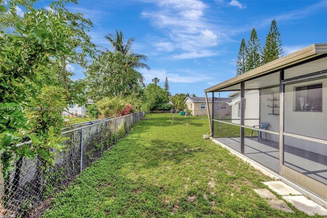 1920 SW 65th Ter, North Lauderdale, FL 33068 - view of yard with a sunroom and a patio area