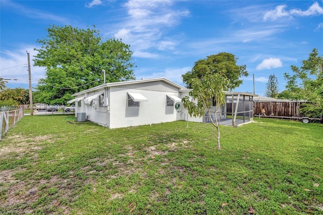 1920 SW 65th Ter, North Lauderdale, FL 33068 - rear view of property with a sunroom, stucco siding, and central AC