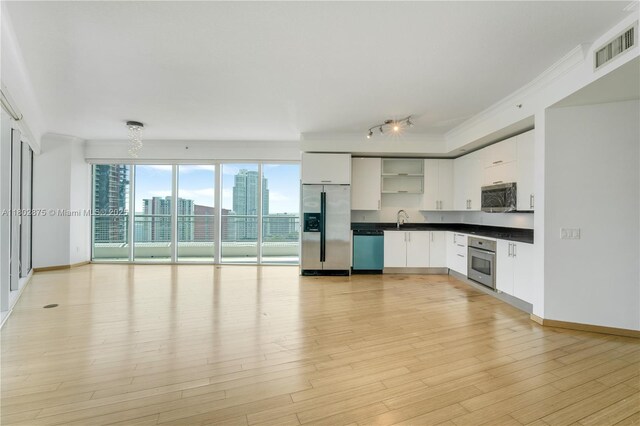 60 SW 13th St Unit 2100, Miami, FL 33130 - kitchen featuring appliances with stainless steel finishes, open shelves, dark countertops, white cabinetry, and light wood-style floors