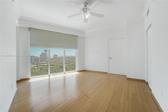 60 SW 13th St Unit 2100, Miami, FL 33130 - spare room featuring ceiling fan, wood finished floors, baseboards, crown molding, and a view of city