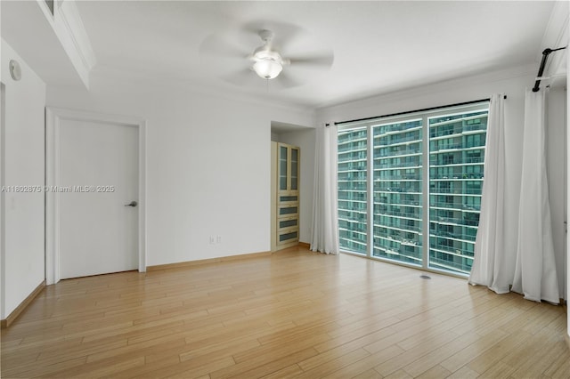 60 SW 13th St Unit 2100, Miami, FL 33130 - spare room featuring ceiling fan, light wood-style floors, and crown molding