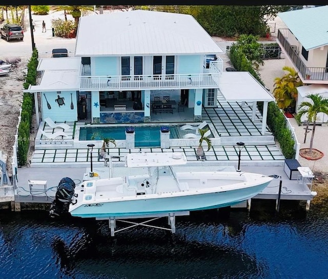 157 La Paloma Rd, Key Largo, FL 33037 - back of house featuring stairway, a water view, a balcony, and a patio