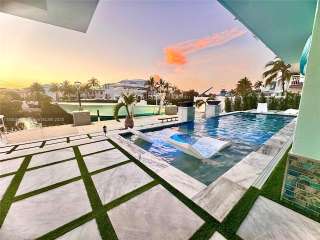 157 La Paloma Rd, Key Largo, FL 33037 - pool at dusk with an outdoor pool, a patio area, and a hot tub