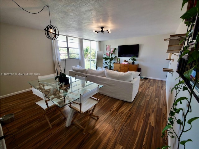 16518 NE 26th Ave Unit 305, North Miami Beach, FL 33160 - living area with baseboards, dark wood-style flooring, and a chandelier