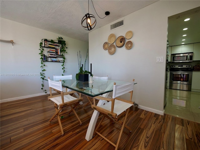 16518 NE 26th Ave Unit 305, North Miami Beach, FL 33160 - dining area with wood finished floors, baseboards, and recessed lighting