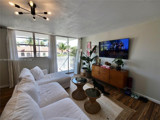 16518 NE 26th Ave Unit 305, North Miami Beach, FL 33160 - living area with baseboards, wood finished floors, a textured ceiling, and a chandelier