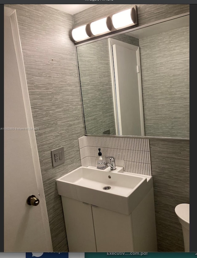 16518 NE 26th Ave Unit 305, North Miami Beach, FL 33160 - bathroom with tile walls, toilet, and vanity