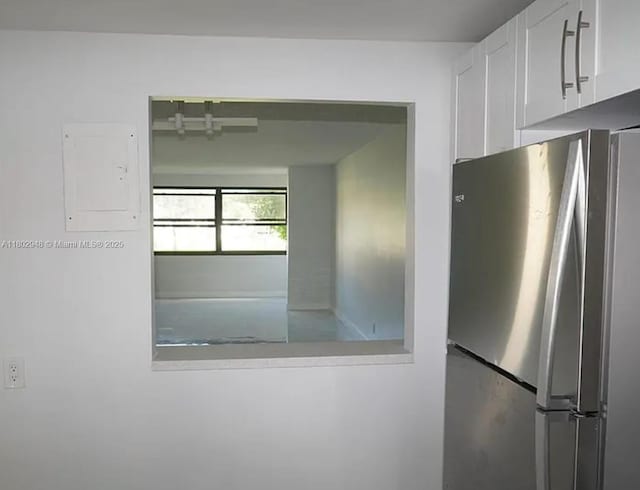 691 S Hollybrook Dr Unit 208, Pembroke Pines, FL 33025 - kitchen view of freestanding refrigerator, white cabinets, and electric panel